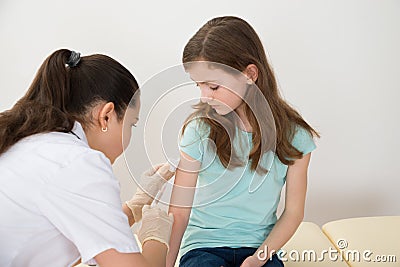 Doctor Injecting Syringe To Patient Stock Photo