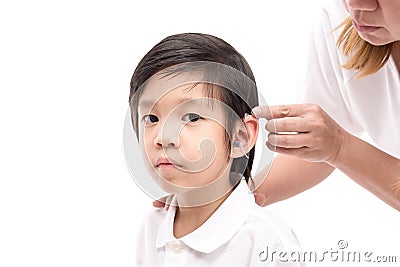 Doctor Inserting Hearing Aid Stock Photo