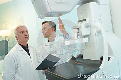 Doctor instructing medical staff about ct scanner procedure Stock Photo