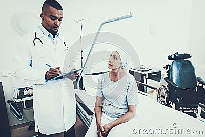 Doctor Interviews. Woman Undergoes Rehabilitation. Stock Photo