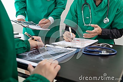 doctor joins a meeting with the surgeon's team to discuss a plan for cancer surgery after the medical team detects cancer. Stock Photo