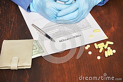 Doctor in latex gloves writes a prescription for pills. money health costs Stock Photo