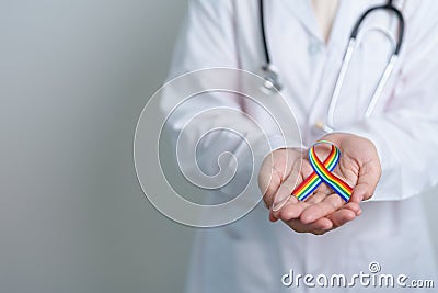 Doctor with LGBTQ Rainbow ribbon for Support Lesbian, Gay, Bisexual, Transgender and Queer community and happy Pride month concept Stock Photo