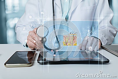 Doctor listens to interface with studying skin anatomy Stock Photo