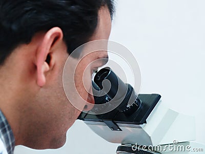 Doctor Looking In Microscope Stock Photo