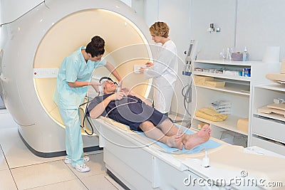 Doctor looking at patient going through ct scan Stock Photo