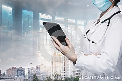 The doctor looks at a mobile tablet Stock Photo