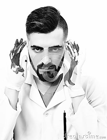 Doctor with mad face expression holds his bloody hands up Stock Photo