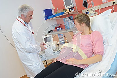 Doctor makes echography pregnant woman Stock Photo