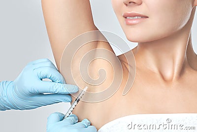 The doctor makes intramuscular injections of botulinum toxin in the underarm area against hyperhidrosis. Cosmetology skin care Stock Photo