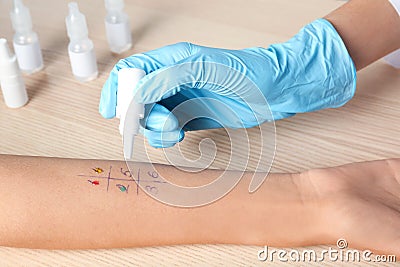 Doctor making allergy test at table Stock Photo