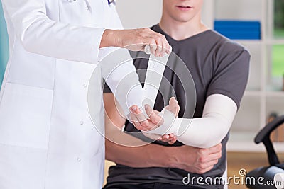 Doctor making cast of upper limb Stock Photo