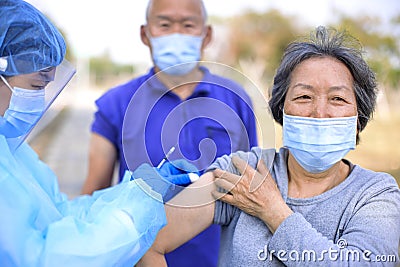 Doctor making injection covid-19 vaccine to senior people Stock Photo