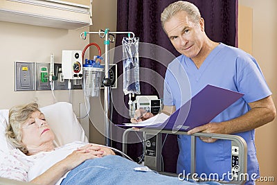 Doctor Making Notes About His Patient Stock Photo