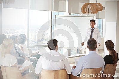 Doctor Making Presentation To Medical Staff In Hospital Stock Photo