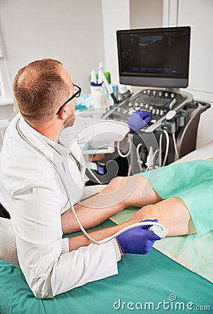 Doctor making ultrasound diagnostics, patient lying on coach. Stock Photo