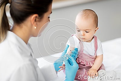 Doctor making vaccine for baby patient at clinic Stock Photo