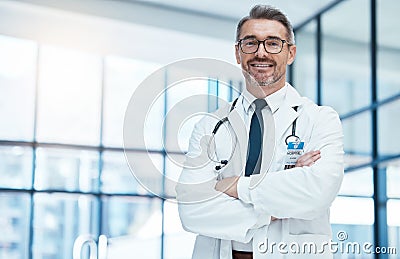 Doctor, man and happy with arms crossed in hospital for medical, career and happiness for portrait. Medic, smile and Stock Photo