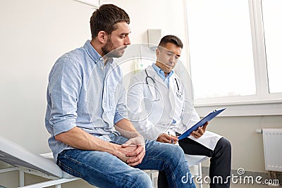 Doctor and man with health problem at hospital Stock Photo