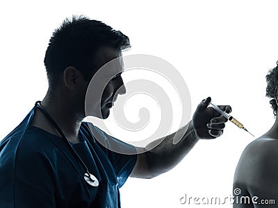 Doctor man holding hypodermic syringe silhouette Stock Photo