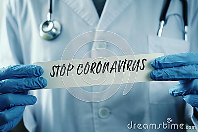 Doctor man showing the message stop coronavirus Stock Photo