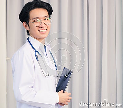 Doctor man smiling in uniform and stethoscope neck strap tablet on hand Stock Photo