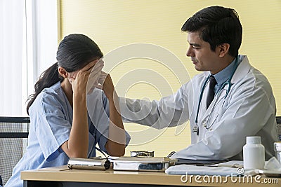 Doctor man wear uniform with pen stethoscope sitting in office while talking about problem health patient woman fell friendly Stock Photo