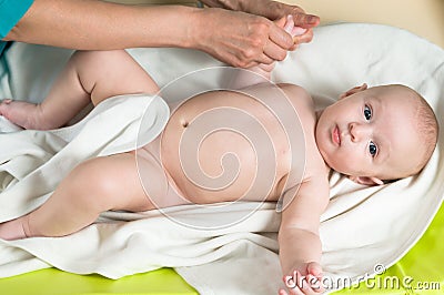 Doctor massaging baby Stock Photo