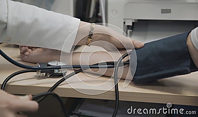 Doctor measures blood pressure of patient Stock Photo