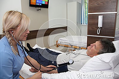 The doctor measures the blood pressure of the patient. Editorial Stock Photo