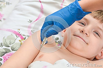 The doctor measures the temperature of a sick child with a medical thermometer Stock Photo