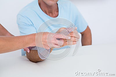 Doctor measuring arm with goniometer Stock Photo