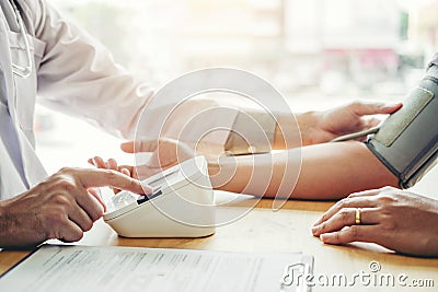 Doctor Measuring arterial blood pressure man patient on arm Health care in hospital Stock Photo