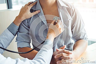 Doctor Measuring arterial blood pressure man patient Health care in hospital Stock Photo