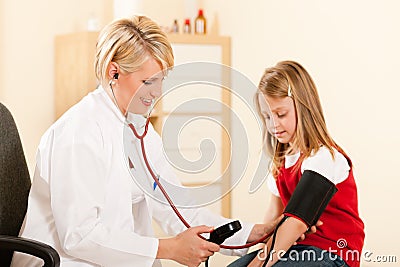 Doctor measuring blood pressure of child Stock Photo