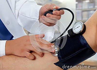 Doctor measuring blood pressure with sphygmomanometer Stock Photo