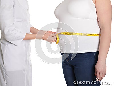 Doctor measuring waist of overweight woman on white, closeup Stock Photo