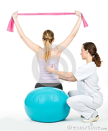 Doctor with medical ball and woman patient Stock Photo