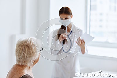 doctor in medical mask stethoscope in hand medical specialist Stock Photo