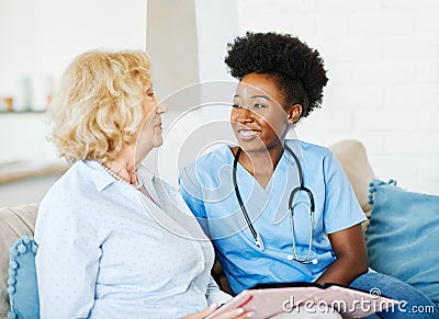 nurse doctor senior care caregiver help assistence retirement home nursing elderly woman health support african american Stock Photo