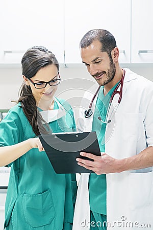 Doctor and nurse examining report of patient Stock Photo