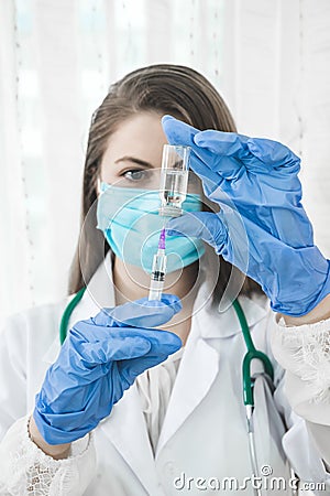 Doctor or nurse filling syringe Stock Photo