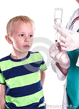 Doctor or nurse preparing injection of little boy. Stock Photo