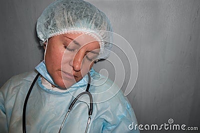 Doctor or nurse sleep. Coronavirus COVID-19 pandemic. Tired, exhausted woman in uniform is sleeping in hospital or clinic after Stock Photo