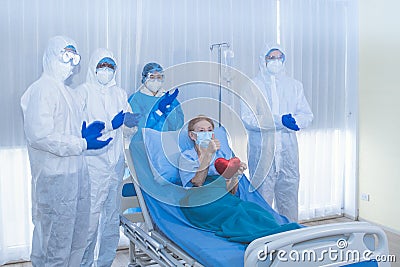 Sucessful Recovering patient resting on bed hold mini heart during Covid-19 outbreak. Stock Photo