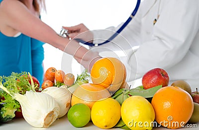 Doctor nutritionist measuring blood pressure of his patient Stock Photo