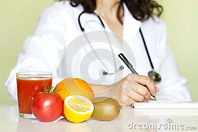 Doctor nutritionist in office with healthy fruits Stock Photo