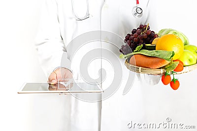 Doctor nutritionist working of case history in tablet at the clinic office Stock Photo