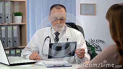 Doctor observing lungs x-ray, patient waiting for diagnosis, tuberculosis risk Stock Photo