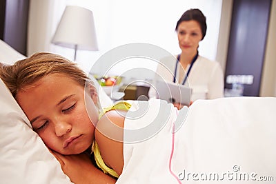 Doctor Observing Sleeping Child Patient In Hospital Bed Stock Photo